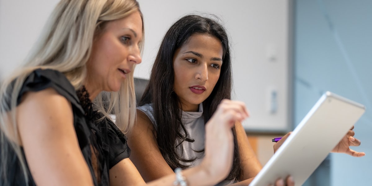 two professional women reviewing document in office