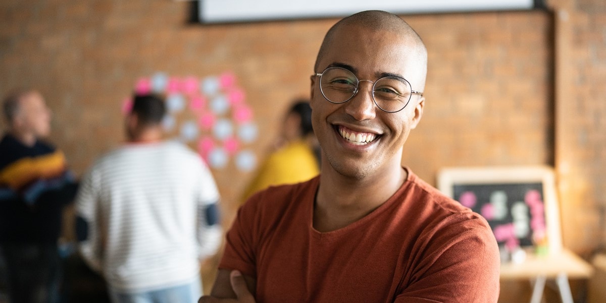 man with glasses smiling in office