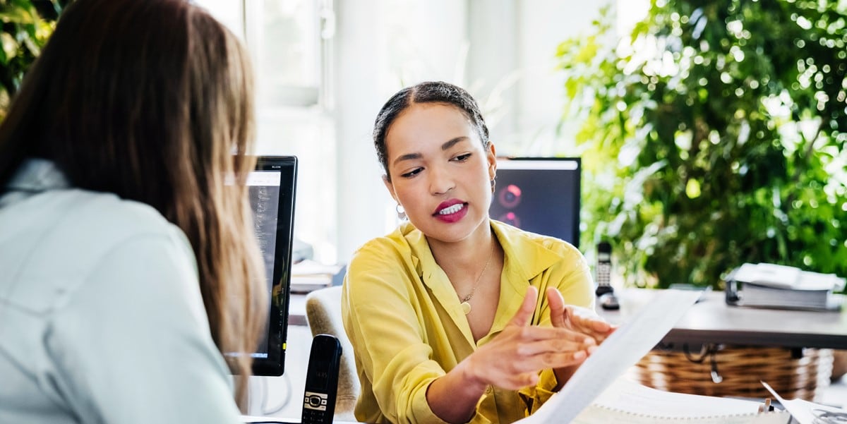 two people in office reviewing document