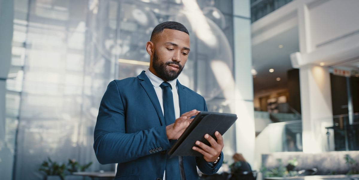 professional man in office holding tablet