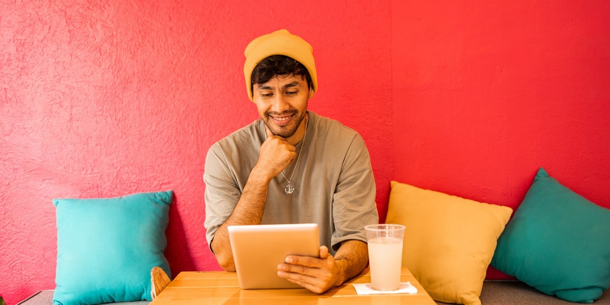 man working at desk, red background